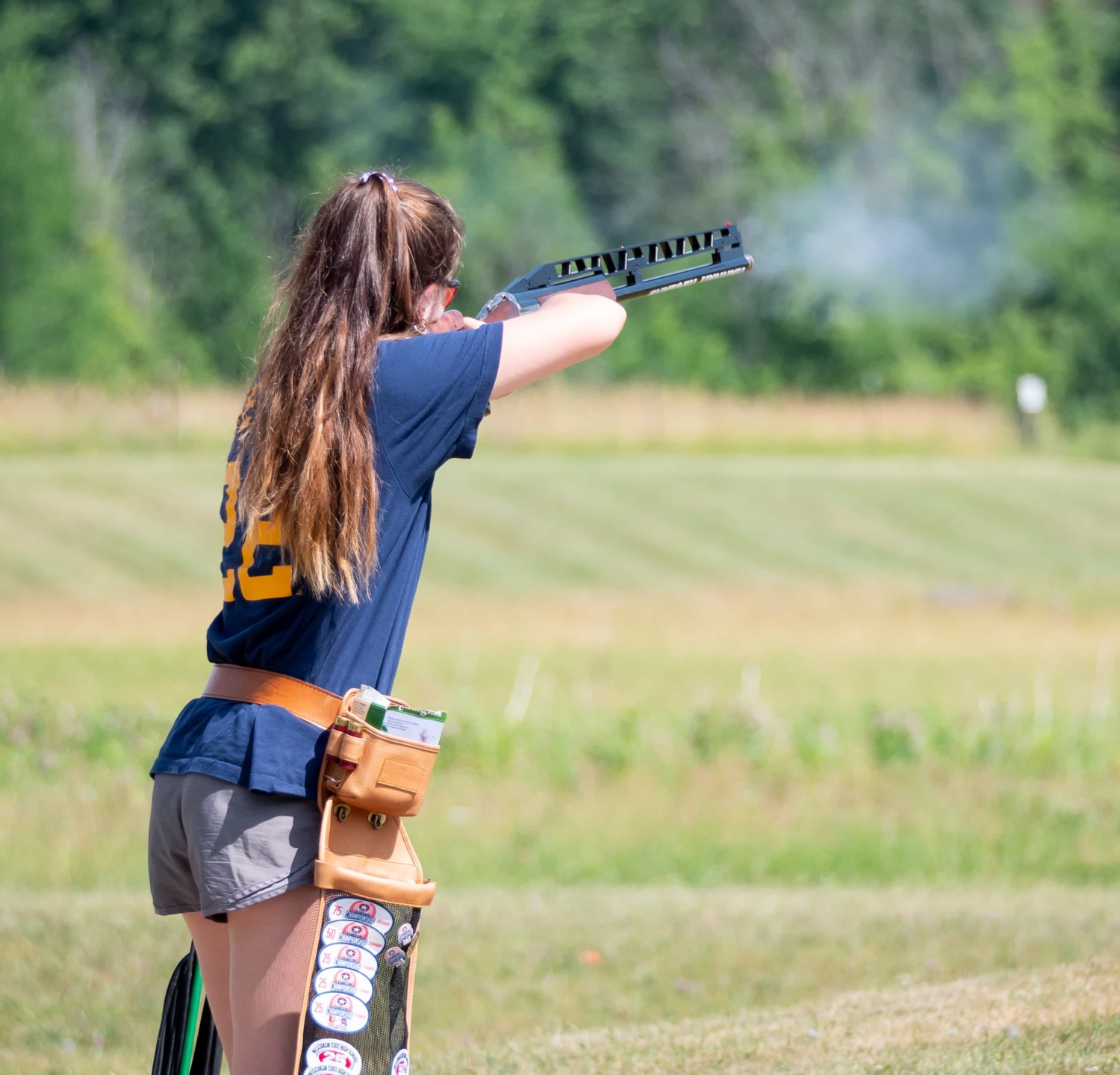A girl shooting a gun at a range.